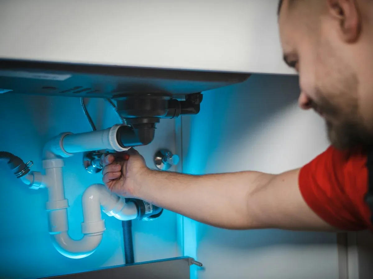 Technician inspecting a water pump system in Dubai